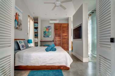 Bright bedroom with wood closet, ensuite, modern tropical colors in Blue Venao Playa Venao Panama