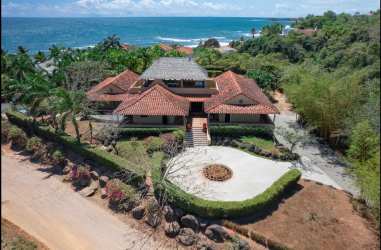 Aerial view luxury Mediterranean villa with red-tiled roof overlooking Pacific Ocean Pedasí Panama