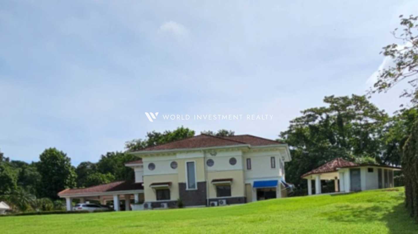 Outdoor swimming pool with jacuzzi surrounded by greenery at Camino de Cruces luxury home Panama