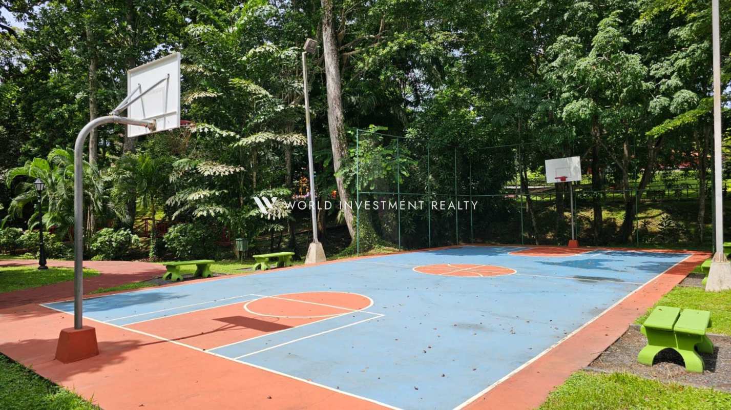 Grand staircase foyer with wrought iron railings and chandelier in Camino de Cruces villa Panama