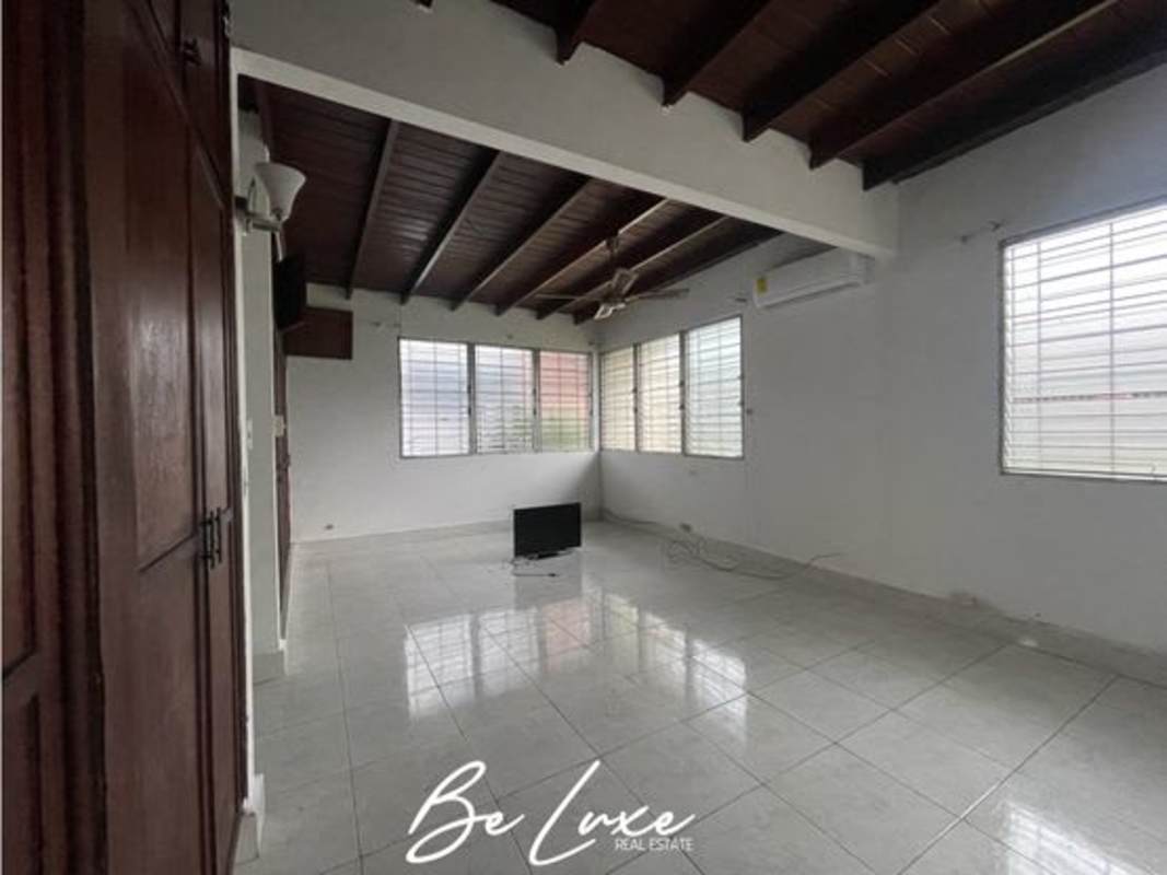 Interior space with exposed beams, large window, AC ready commercial house San Francisco Panama