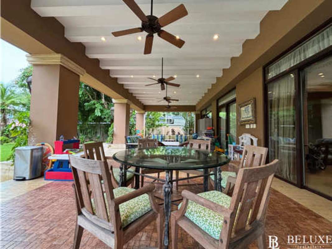 Elegant marble foyer with double staircase and wrought iron railings luxury house Panama