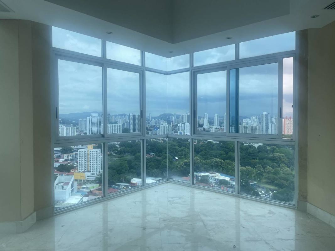 Modern lounge with large panoramic windows and marble flooring PH Keops Tower Penthouse Panama