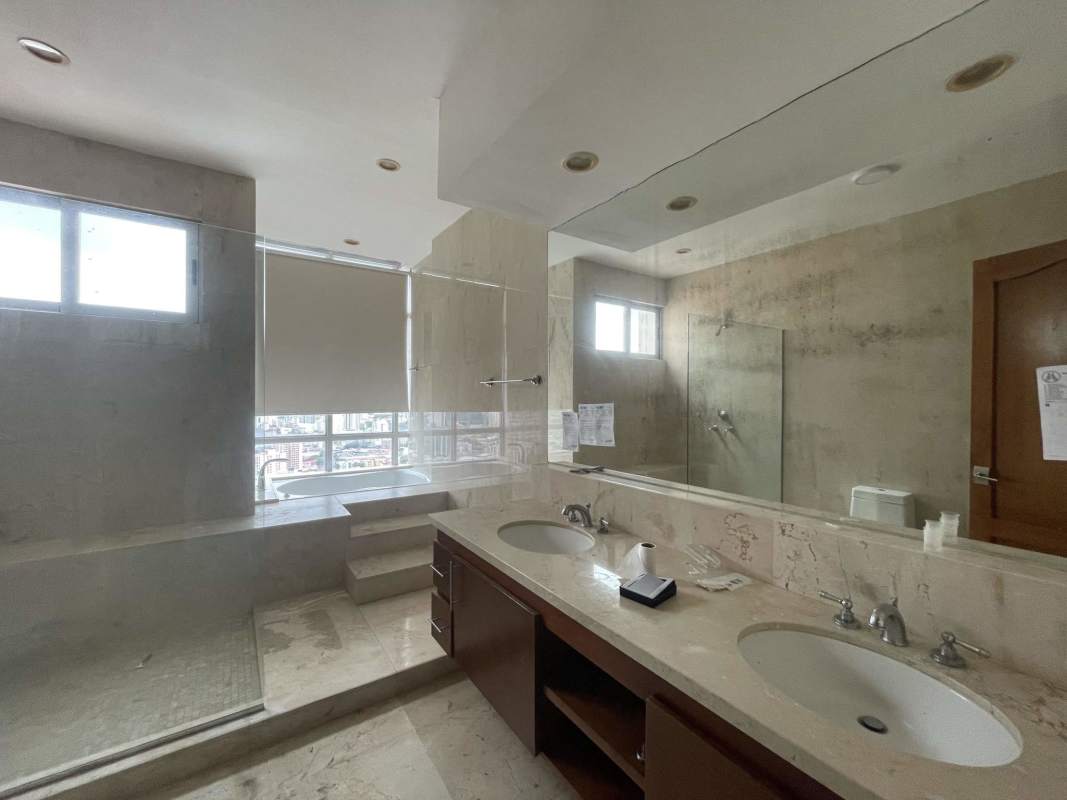 Spacious bathroom with bathtub double vanity and panoramic city view PH Keops Tower Panama