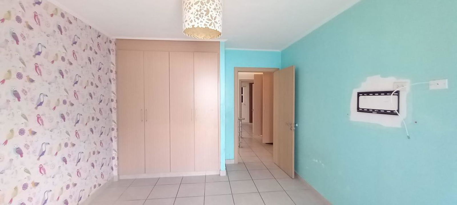 Bedroom with built-in wardrobe tiled floor window light at PH Victoria Brisas del Golf Panama