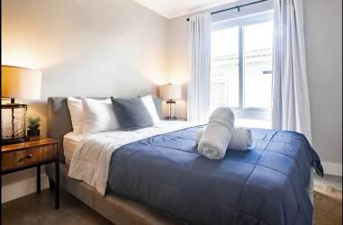 Modern bedroom with queen bed and large window Playa Venao beach rental