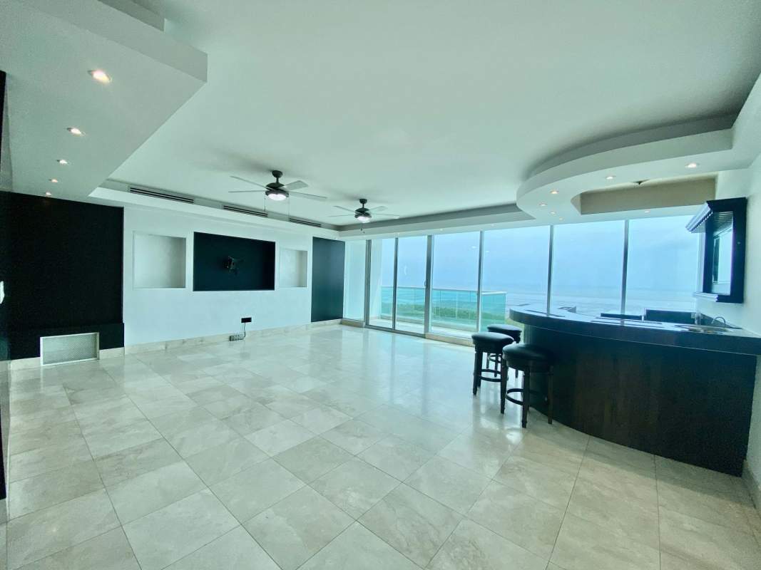 Modern kitchen with granite counters, appliances and dark cabinetry in PH Ocean Two Costa del Este Panama