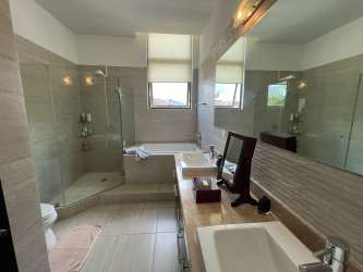 Fully equipped modern kitchen with stainless appliances and dark cabinets in PH Nativa Panama Pacifico