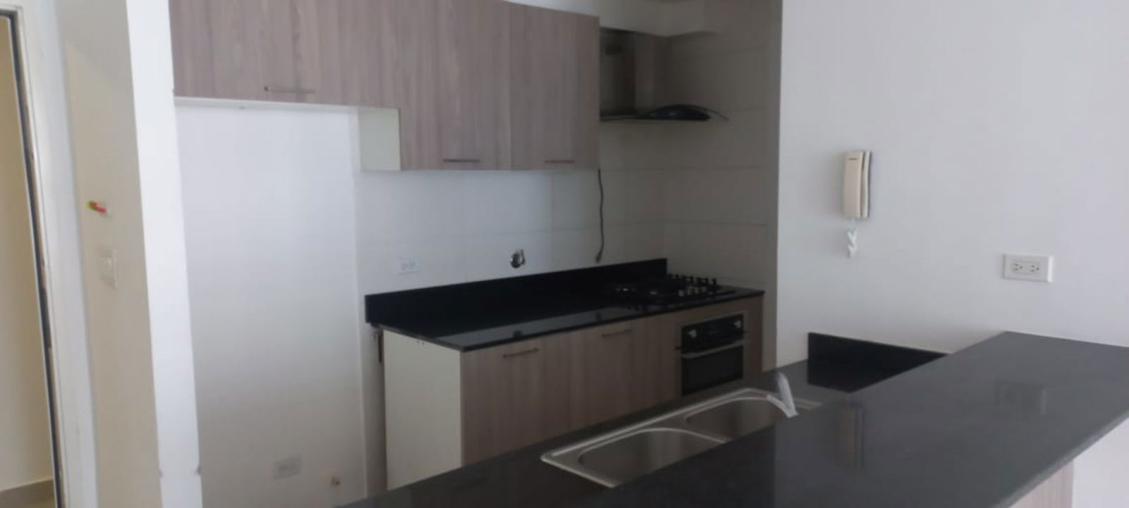 Bright living and kitchen area with open plan layout and tiled floor in PH Coral Towers Carrasquilla Panama