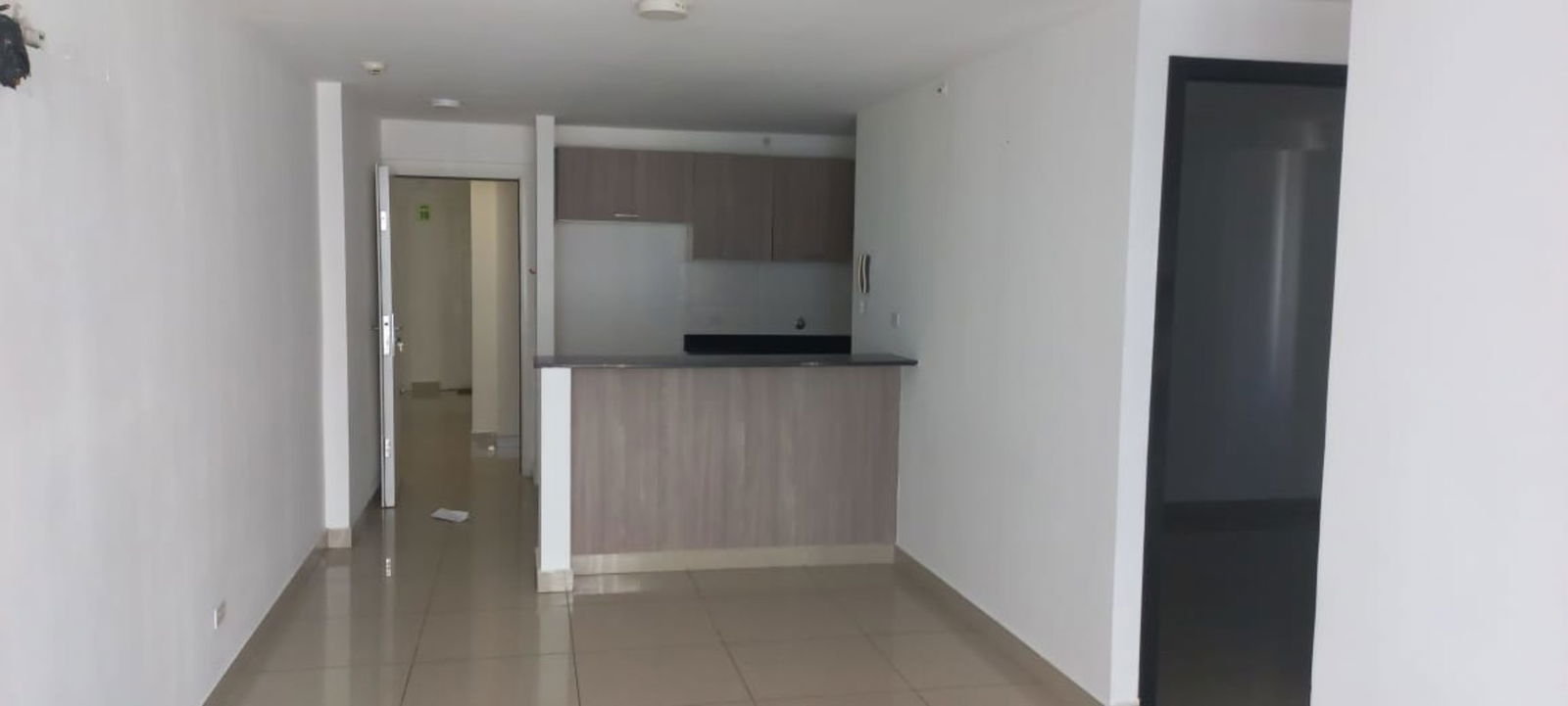 Open plan kitchen with breakfast bar and cabinetry in PH Coral Towers Carrasquilla Panama