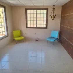 Living room with colored chairs tiled floor grid windows Vacamonte Panama