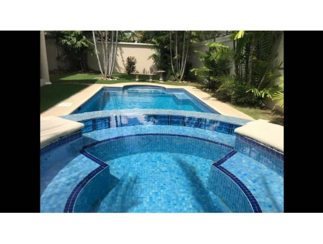 Outdoor swimming pool with tropical garden and privacy wall in Costa Azul Costa del Este Panama