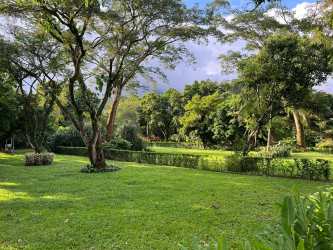 Secure gated community entrance surrounded by lush greenery and mountain backdrop El Valle Panama
