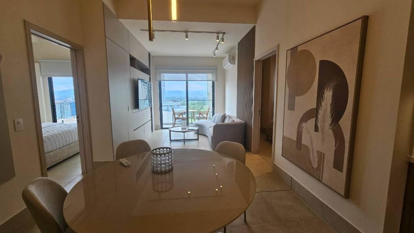 Furnished living dining area with golf view balcony PH Aria apartment Panama