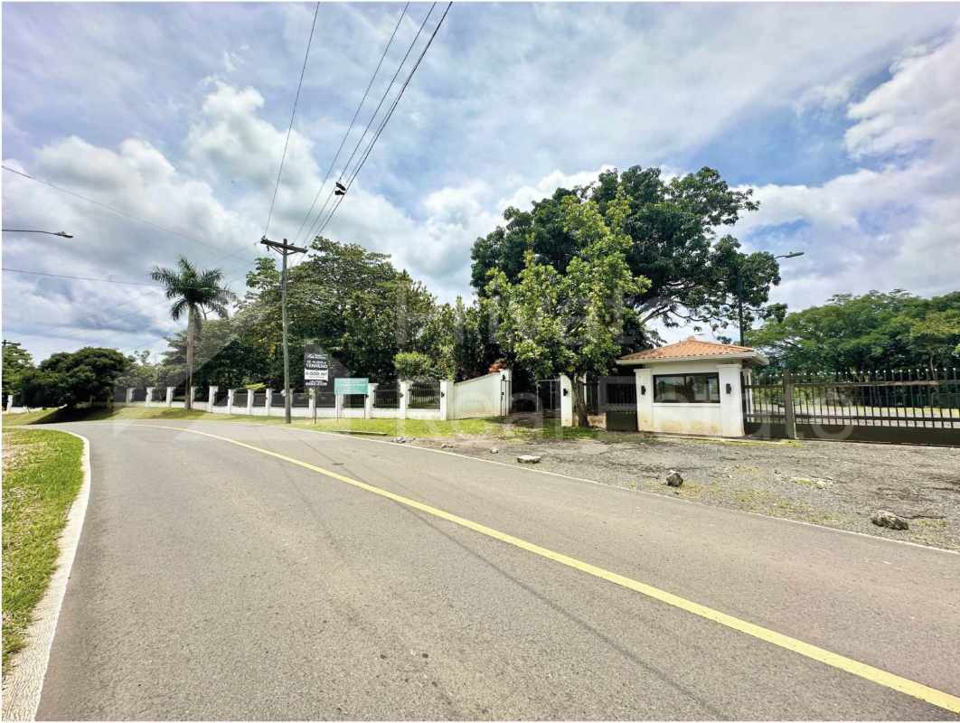 Security fence and metal gate of commercial land rental with access road Rancho Café Panama