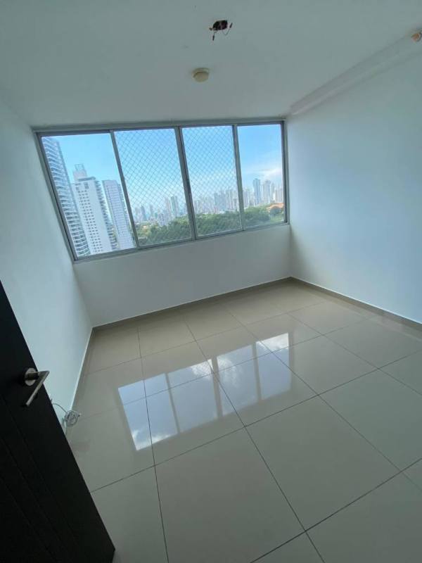 Bedroom with large window overlooking Panama skyline in Sky Park