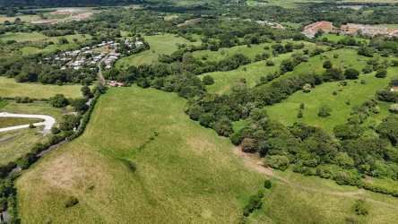 Expansive green fields with residential developments nearby suitable for mixed-use in David Panama