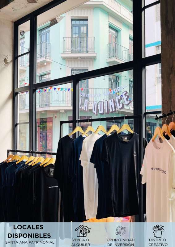 Interior view of commercial retail unit with industrial windows and clothing racks in Santa Ana, Casco Viejo