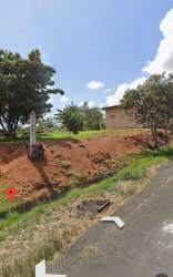 Elevated countryside lot with roadside embankment and residential building La Chorrera Panama