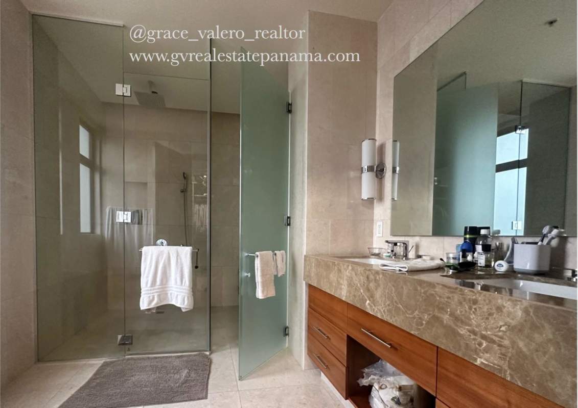 Luxury bathroom with glass-enclosed shower, marble countertop and double sink vanity in Santa María Panama