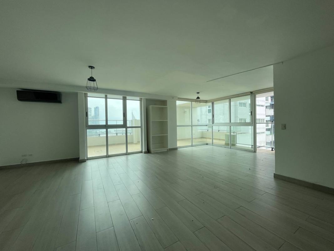 Living room with large windows, balcony access, tile flooring in PH Belle View Bella Vista Panama