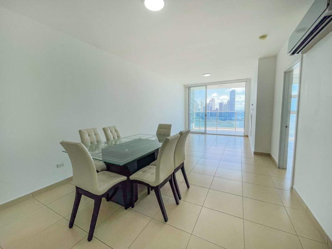 Open dining room next to modern kitchen with tile floors PH White Tower Panama City