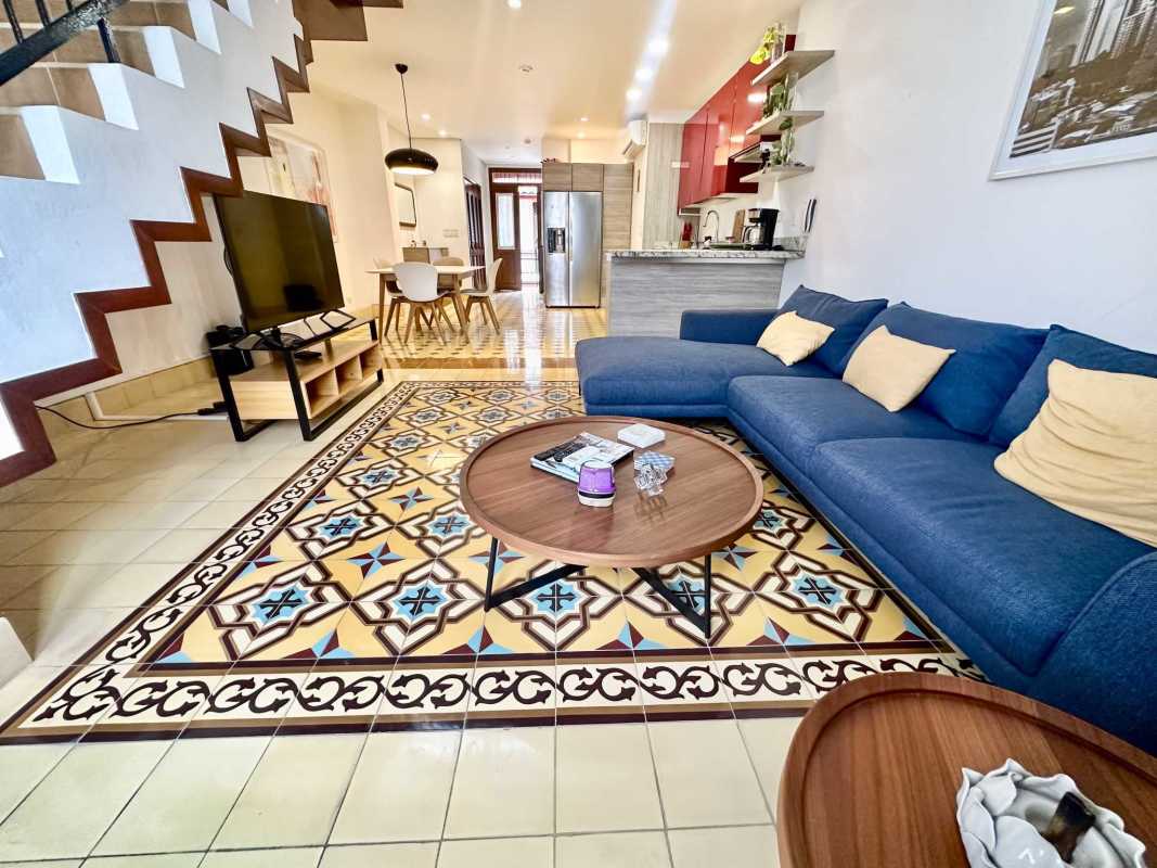 Open living dining with tile flooring open staircase modern kitchen Casco Viejo loft Panama