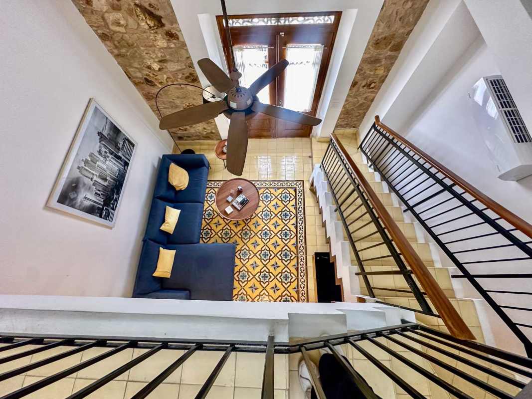 Kitchen with granite countertops red cabinetry patterned tile Casco Viejo Panama