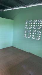 Interior room with mint green walls, tiled floor, ventilation blocks La Chorrera Panama affordable rental