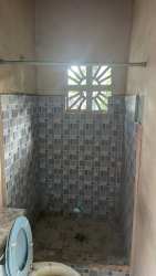 Simple bathroom with shower, ventilation, tiled walls affordable rental La Chorrera Panama