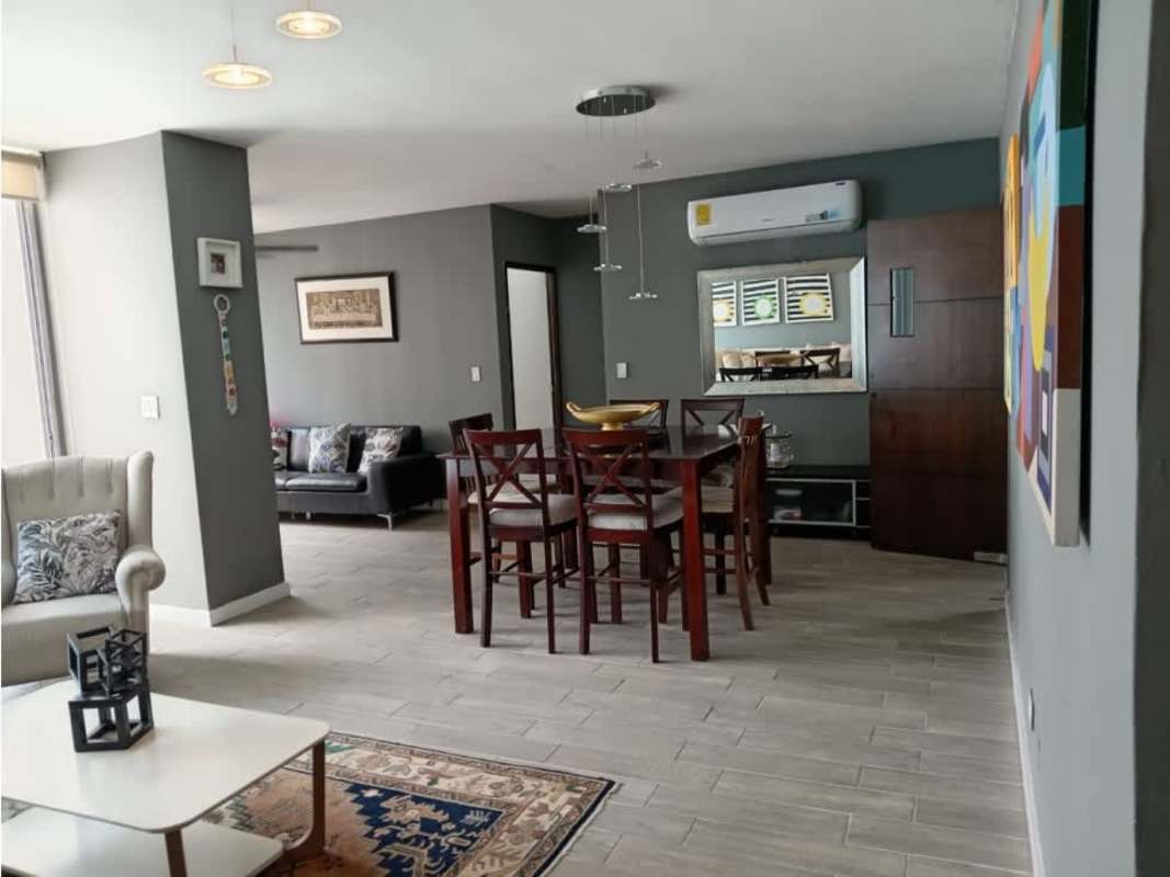 Elegant entrance lobby with seating area, glass wall and chandelier at PH San Francisco Bay Panama