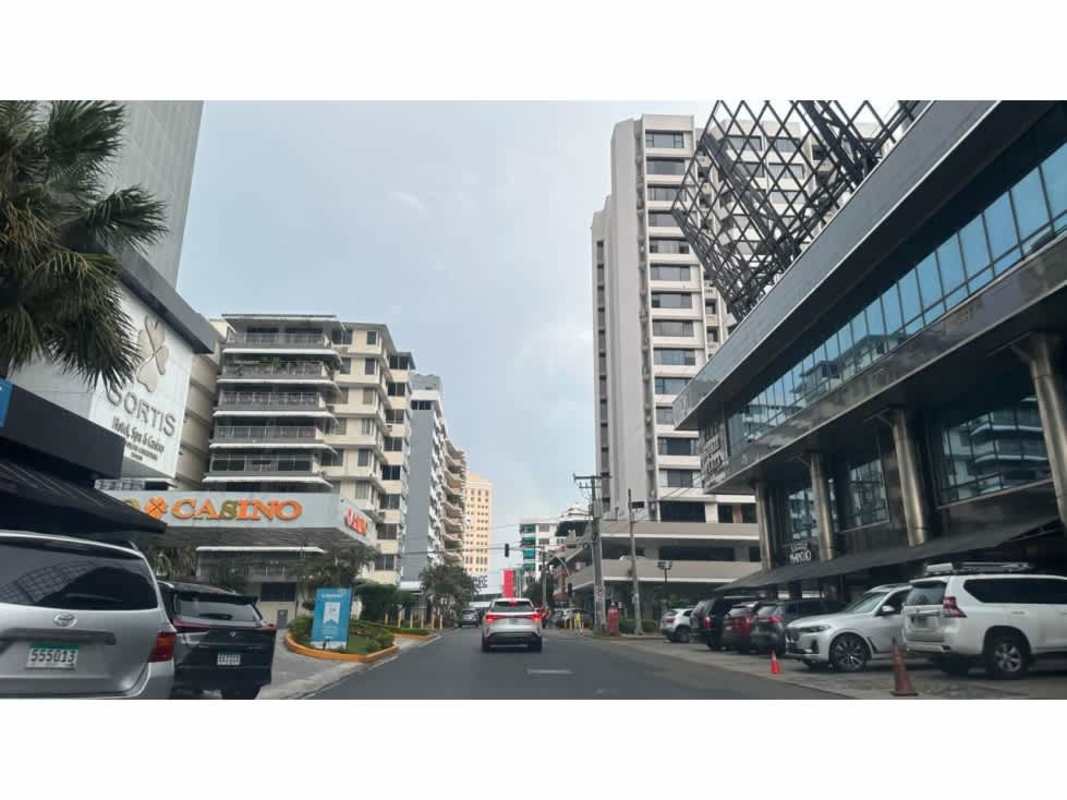 Cityscape featuring modern commercial towers, spiral skyscraper, busy street in downtown Obarrio Panama City