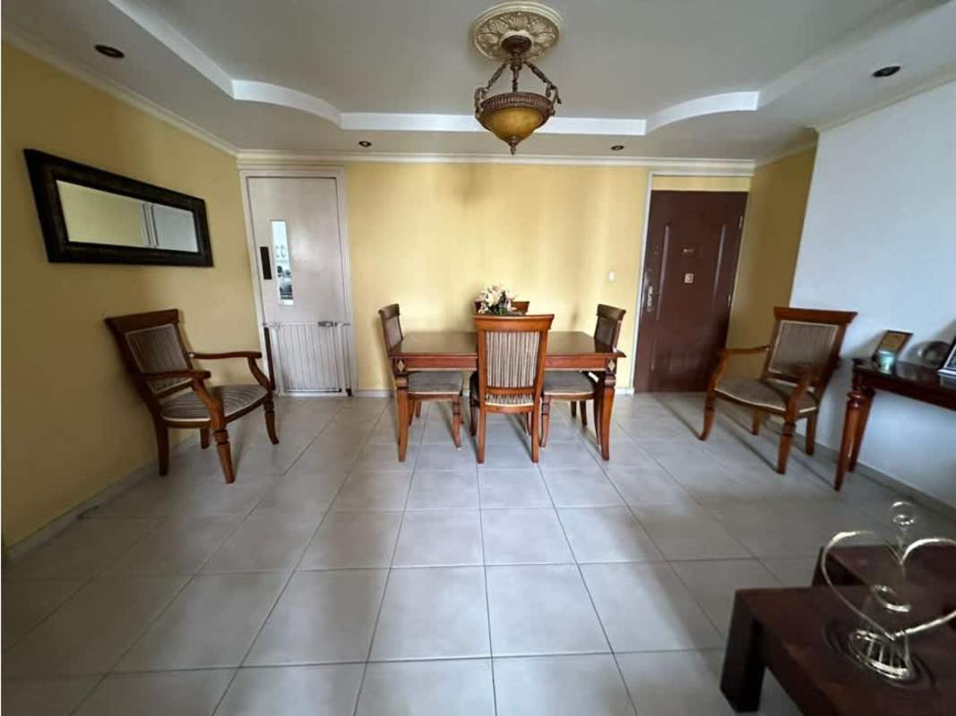 Dining room with wood furniture, tray ceiling, tile floors PH Mirador San Francisco Panama