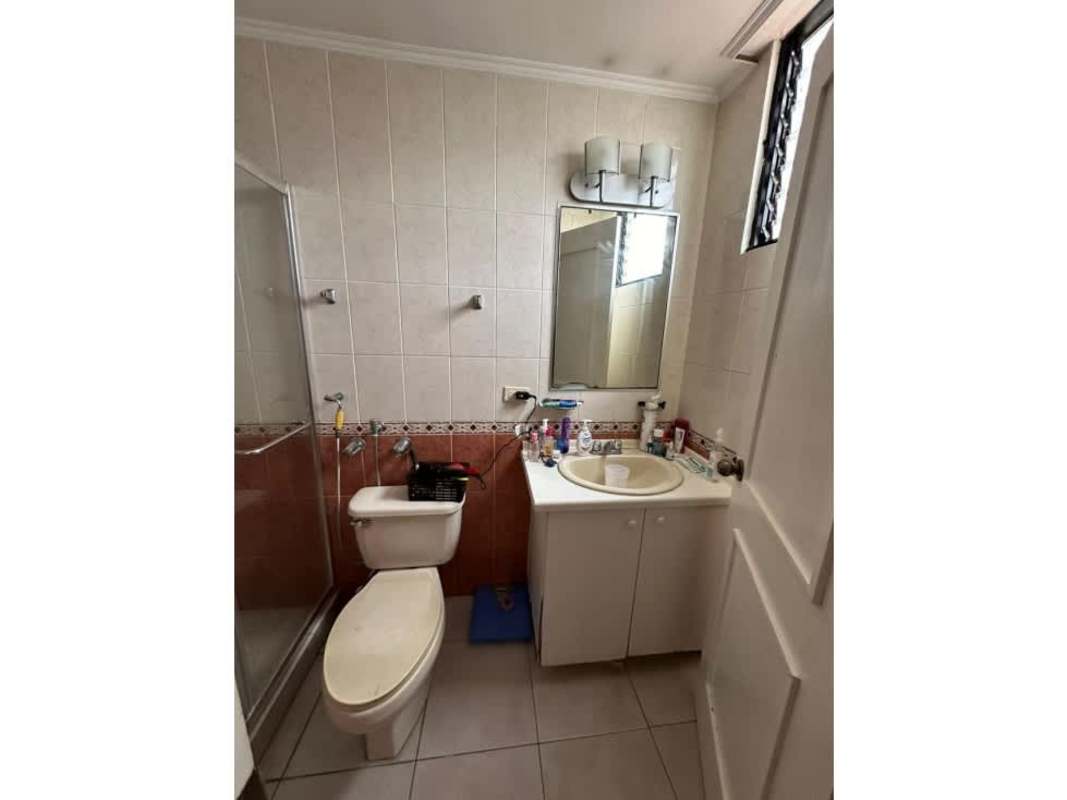 Traditional style bathroom with glass-enclosed shower, vanity cabinet, mirror in Panama City condo