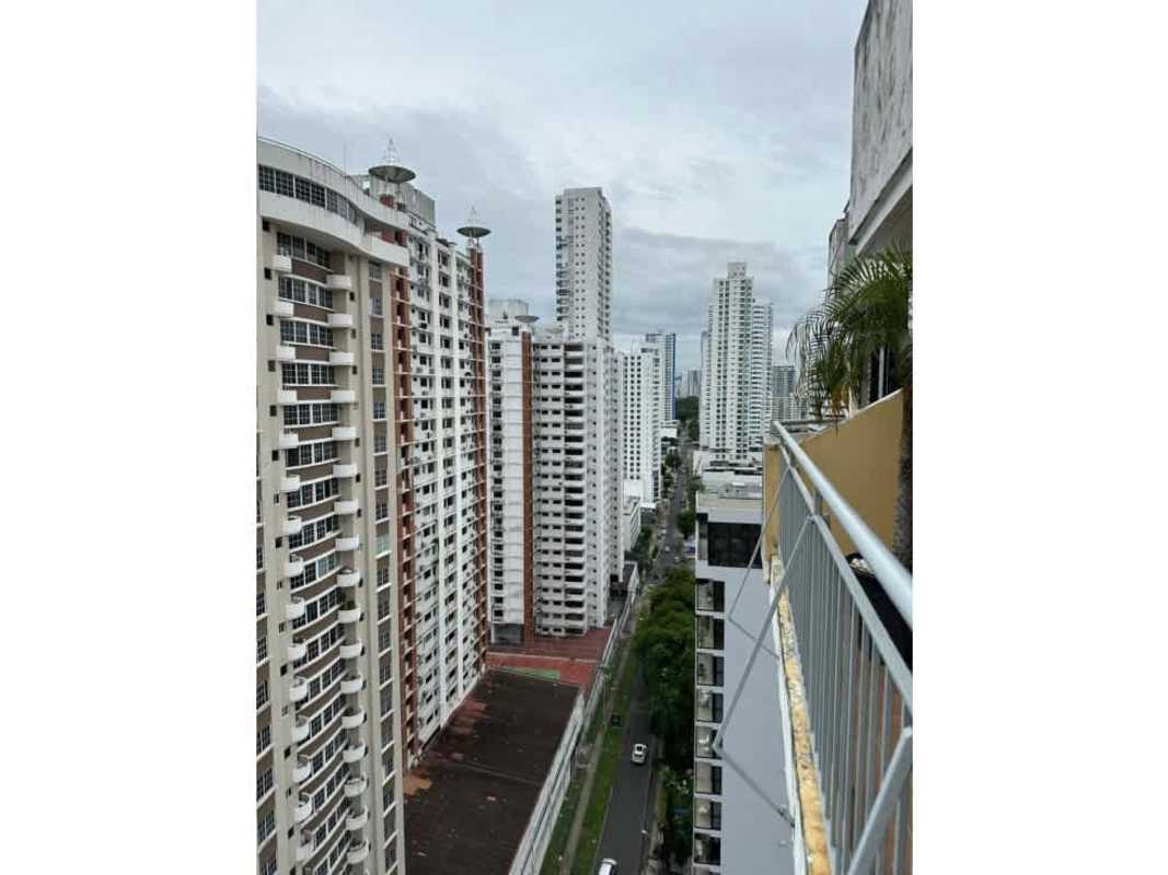 Gym with exercise equipment, large windows, panoramic urban views in Panama condominium