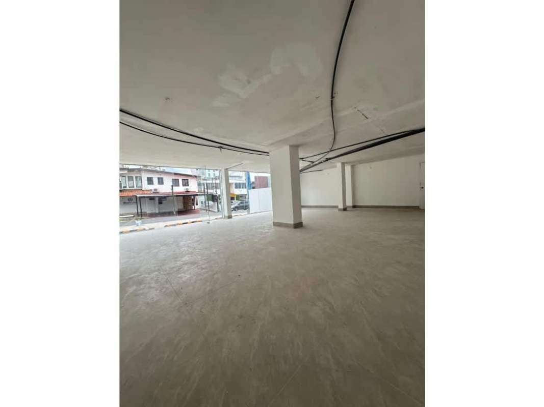 Empty open-floor commercial interior with tiled flooring, windows, exposed ceiling in San Francisco Panama
