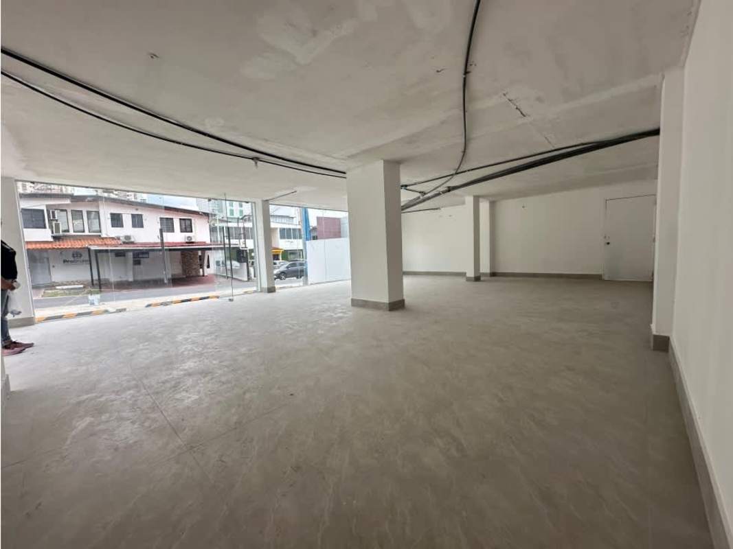 Empty commercial interior with floor-to-ceiling glass windows looking to street in Panama San Francisco