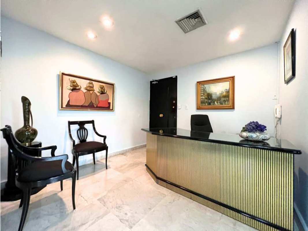 Modern conference room with glass table, skylight, and vertical blinds at PH Advanced Banking District Panama City
