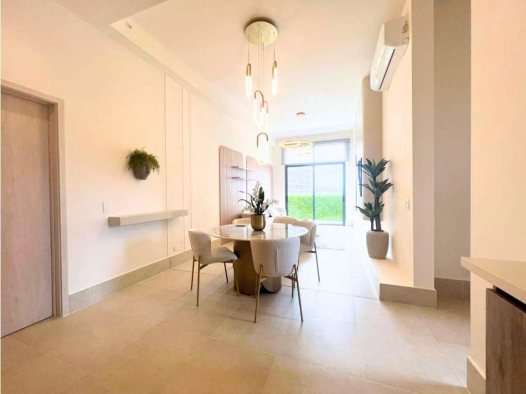 Open plan kitchen dining area with island and pendant lights in PH Ocean House Panama