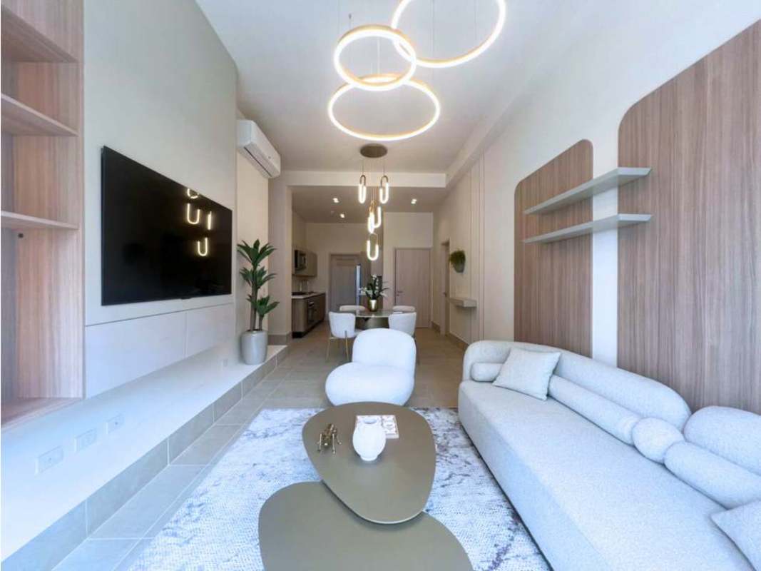 Luxury bedroom with wood accent wall and window at PH Ocean House Santa María Panama