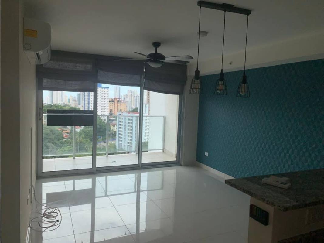 Contemporary kitchen featuring granite counters, stove, fridge, and wood cabinetry in PH Midpark Carrasquilla Panama City