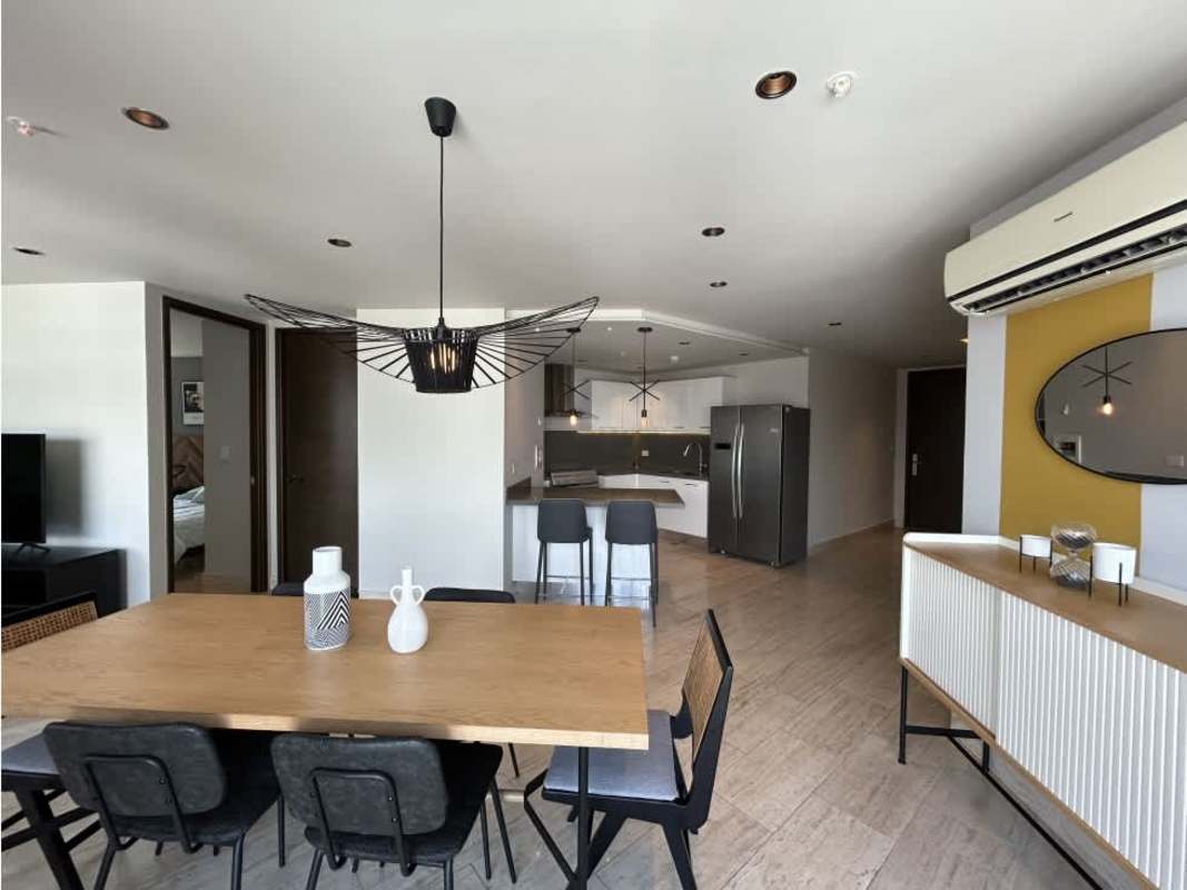 Spacious bedroom with large windows overlooking Costa del Este skyline Panama