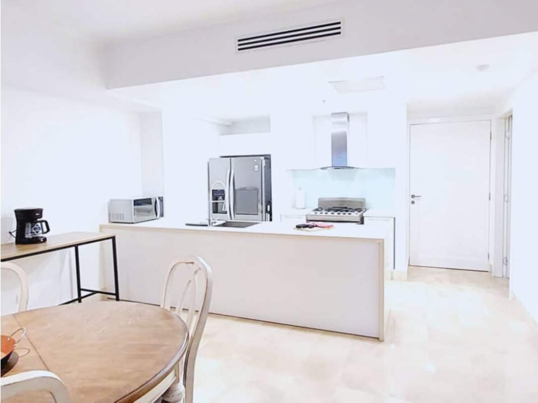 Bright open kitchen with white cabinets and stainless steel appliances at Yoo Panama