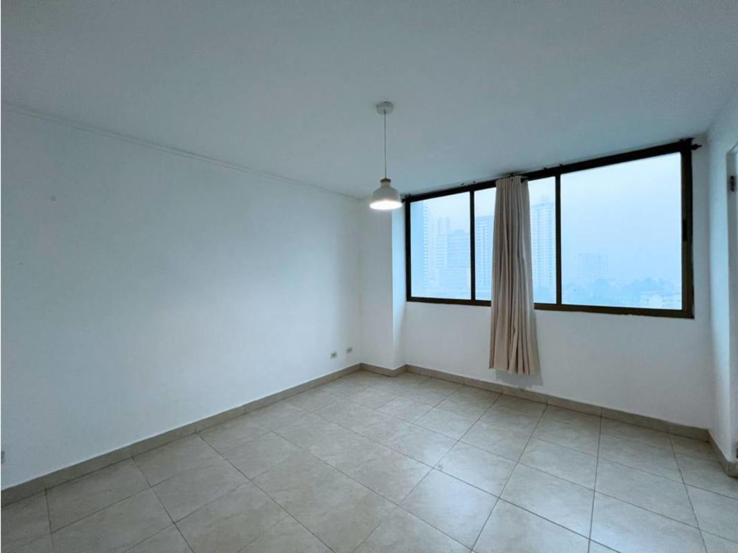 Living room with sliding glass door opening to balcony city skyline PH Blue Bay Tower