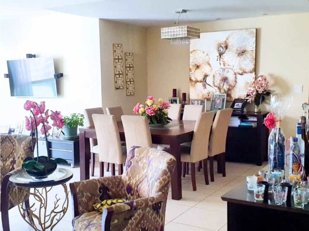 Contemporary dining room with wall art, chandelier, large table in PH Costa View Costa del Este Panama