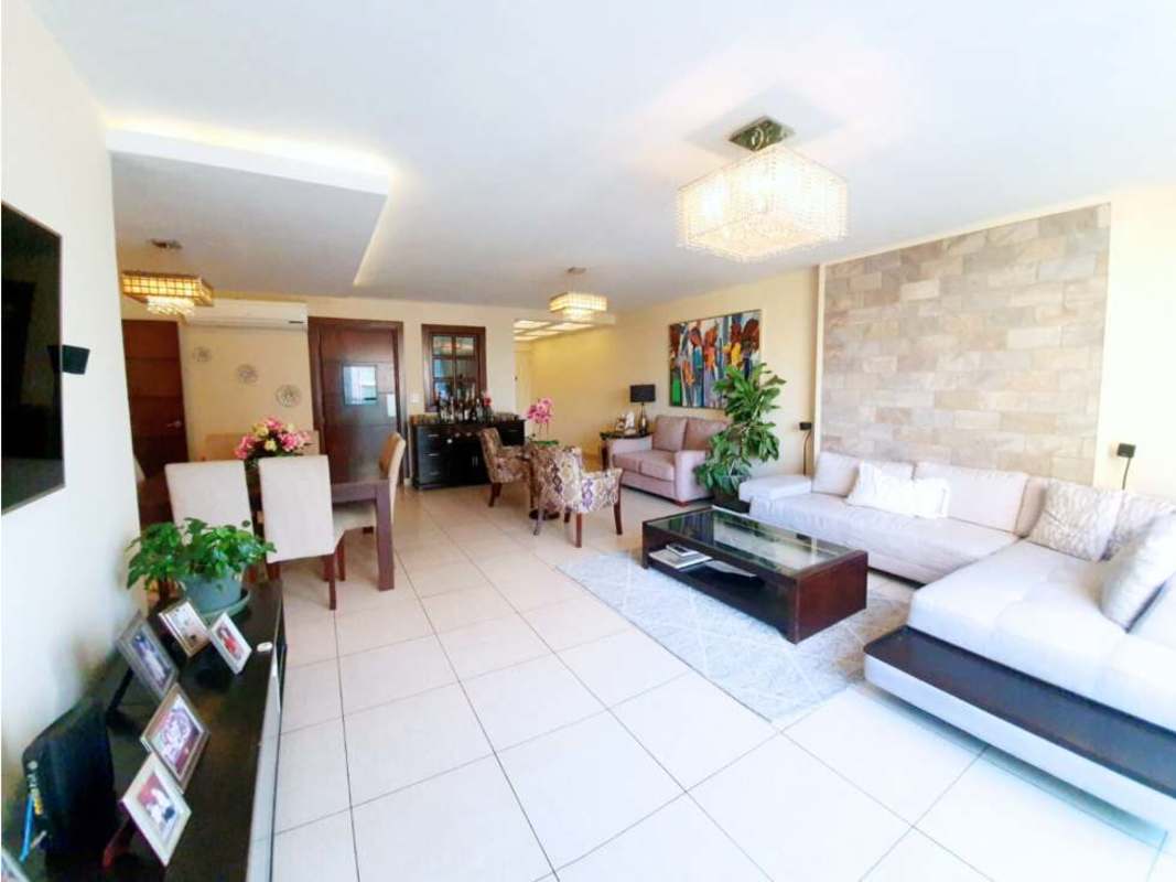 Open living dining with sectional sofa, stone accent wall, chandeliers in PH Costa View Costa del Este Panama