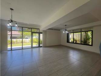 Spacious modern living room with large windows and access to terrace at PH Nativa house Panama Pacifico