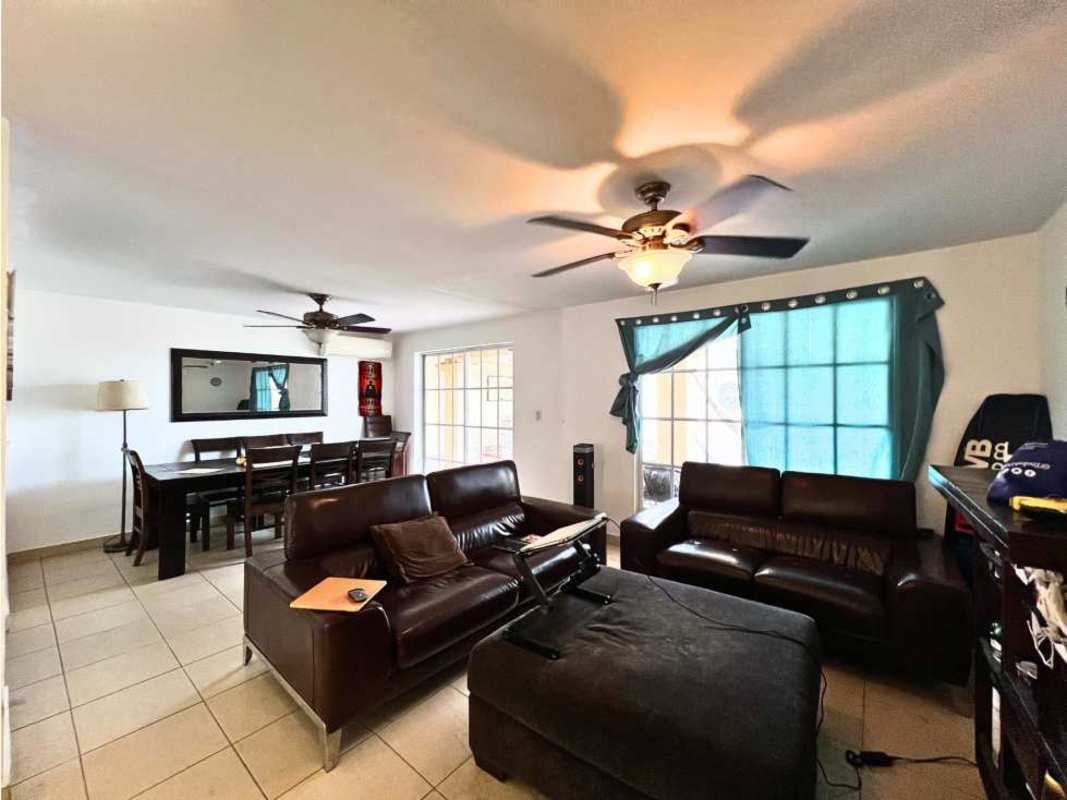 Spacious outdoor patio with covered seating, bar counter, decorative wall art in PH Dorado Spring Panama City