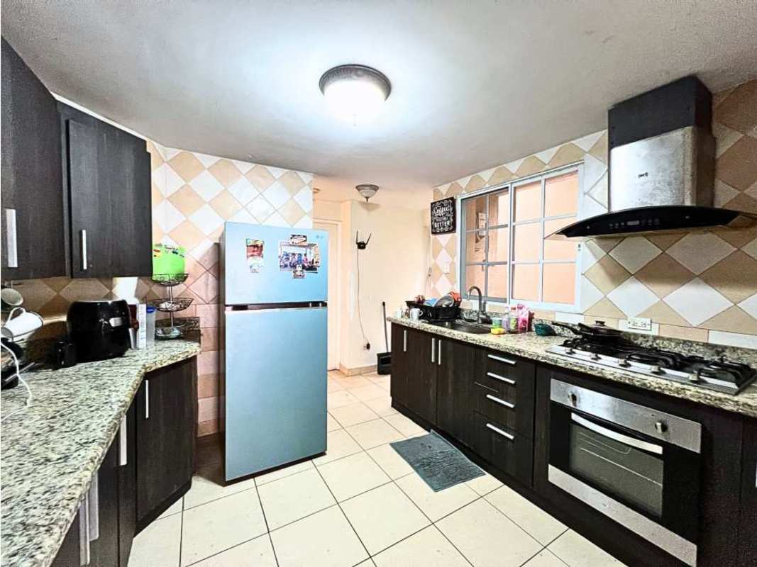 Modern kitchen with granite counters, dark wood cabinets, stainless appliances PH Dorado Spring Panama