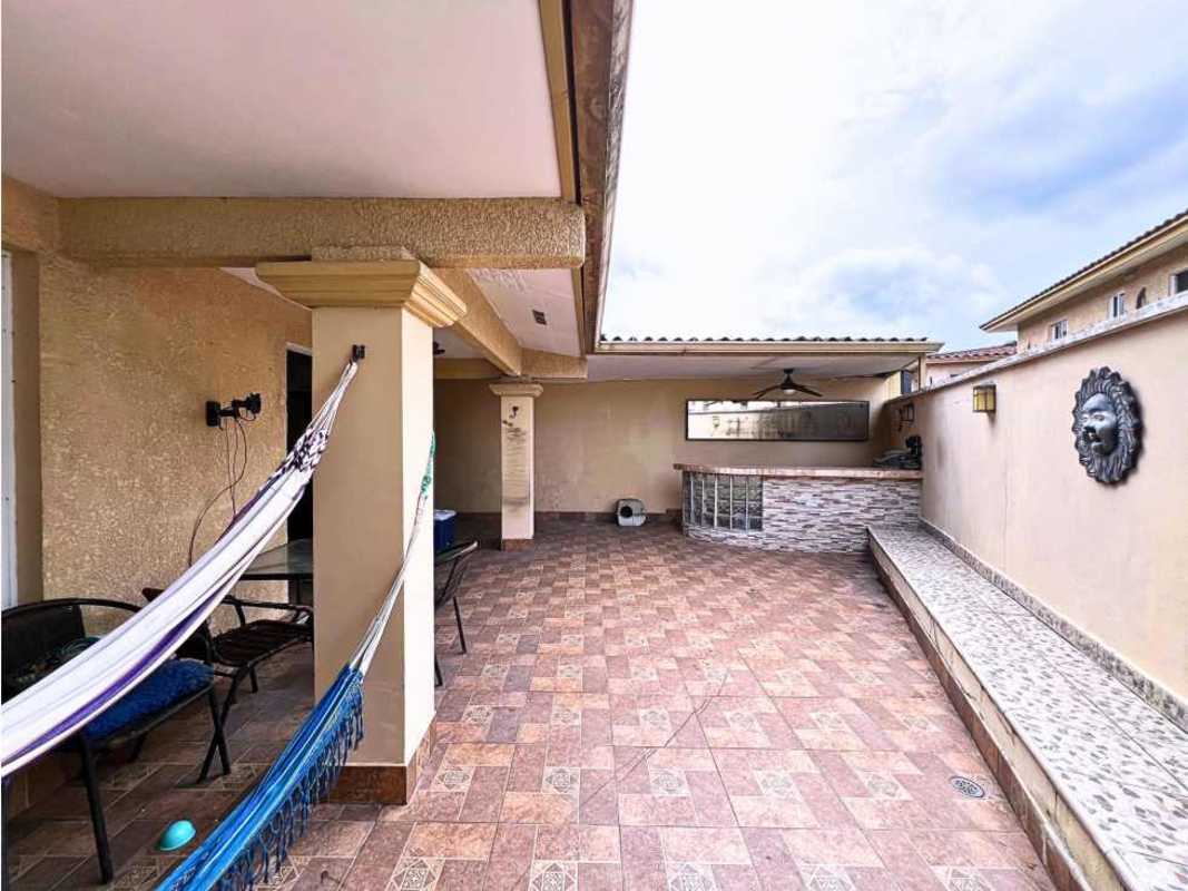 Open living dining area with large window ceiling fans dark sofas PH Dorado Spring Panama